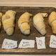 Baked crescent rolls are lined up on a cutting board.